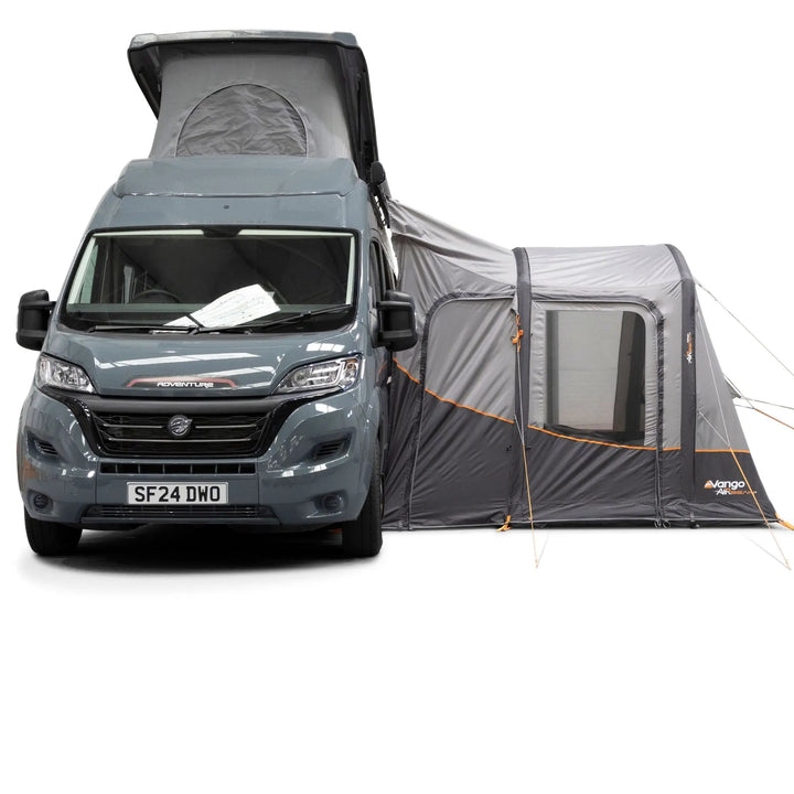 A Vango Faros III Air Mid Drive Away Awning attached to the side of a motorhome van, shown on a clean white background. The tent features window panels, mesh ventilation, and orange zipper accents.