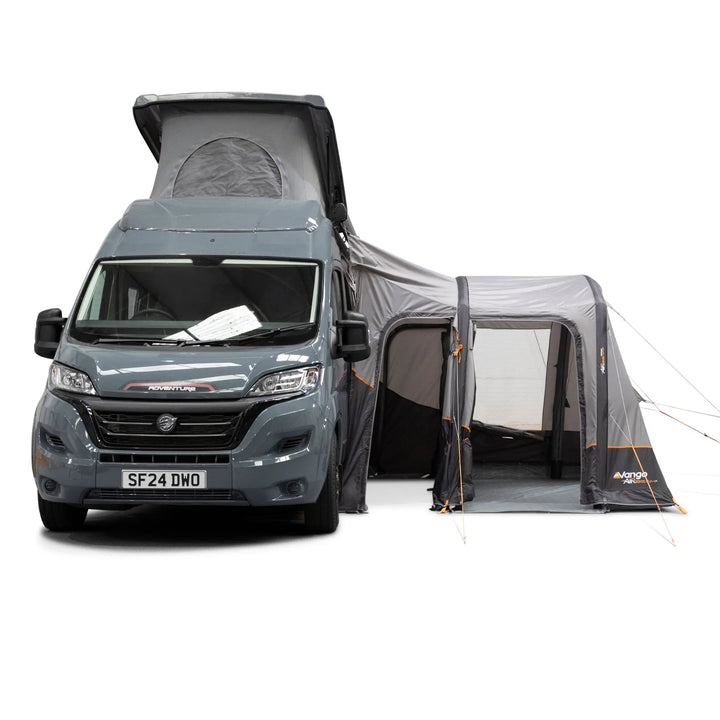 A gray motorhome van with a pop-up roof extended, attached to a Vango Faros III Air Mid Drive Away Awning, shown on a white studio background.