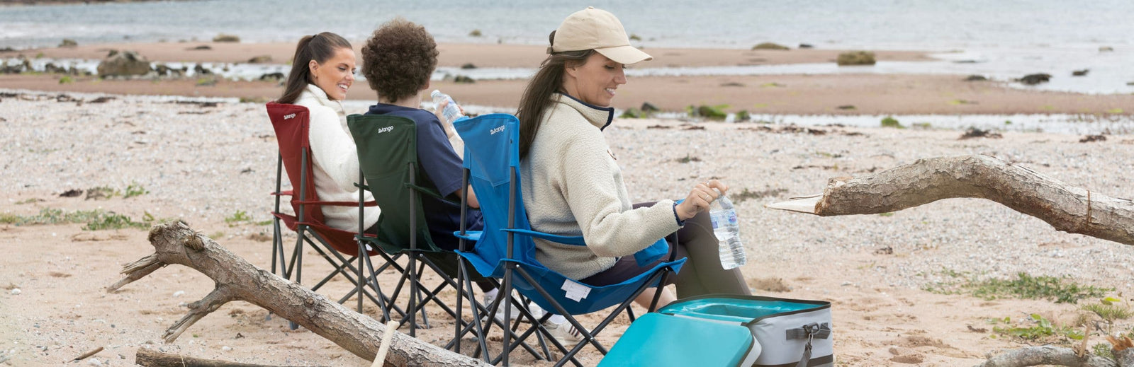 Rear view of three Vango Fiesta Chairs on a beach, demonstrating their durable and lightweight camping chair design for outdoor relaxation.