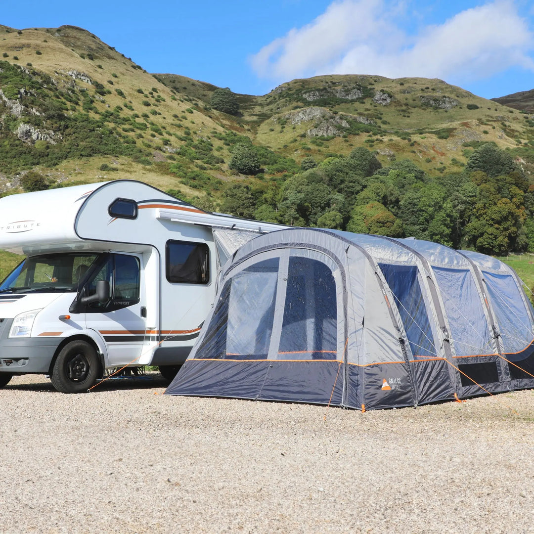 Vango Galli CC II Air Tall Drive Away Awning attached to a motorhome with mountains in the background.