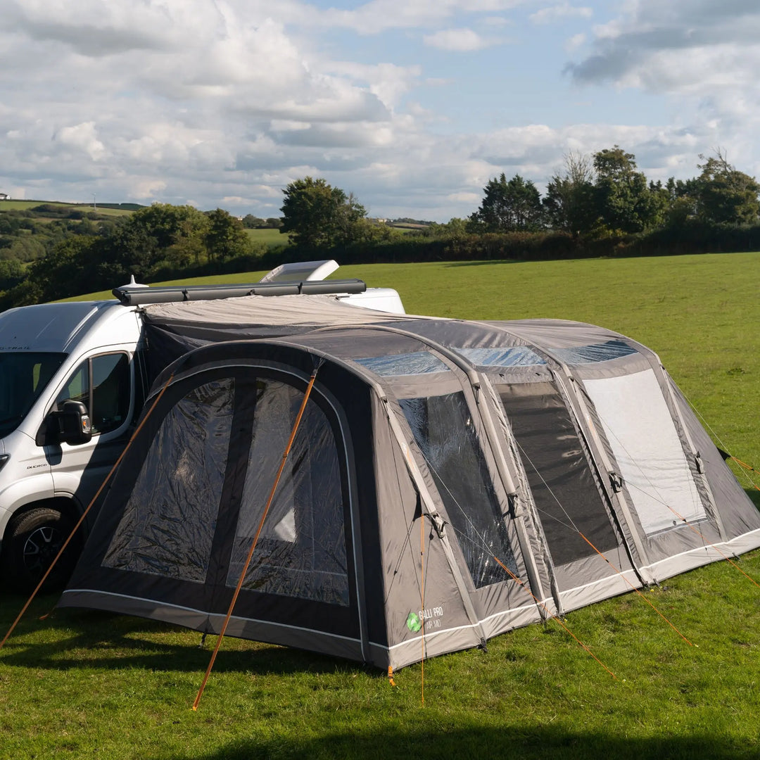 Vango Galli Pro AIR MID Drive-Away Awning pitched in a field attached to van.