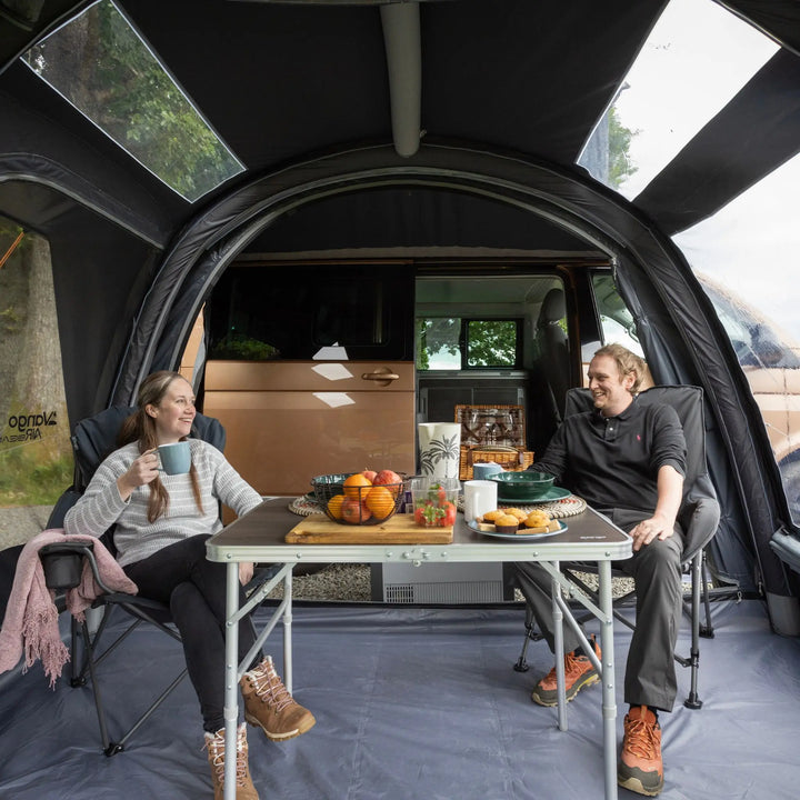Two people sitting in the living area of of the Vango Kela Edition 60 Drive Away Awning.