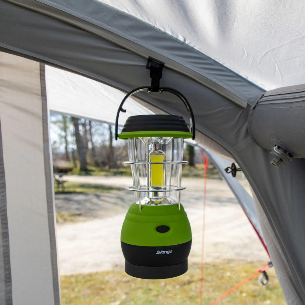 Close-up of the Vango Lunar 250 ECO Rechargeable Lantern suspended inside a tent, highlighting its bright illumination and sturdy hanging hook, suitable for camping lighting.