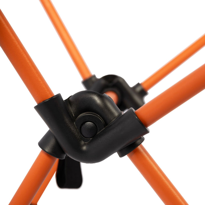 Detailed view of the Vango Micro Chair Excalibur's frame joints, showcasing strong black plastic connectors and orange steel legs.