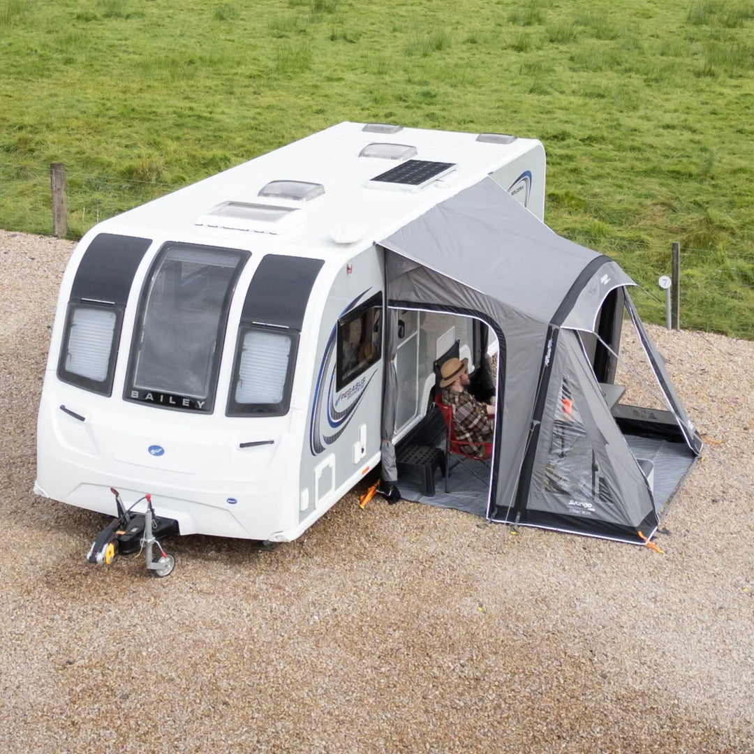 Lifestyle photo of a Vango Palma Air 260 Caravan Awning attached to a caravan on a hard-standing pitch.