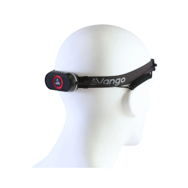 Vango Photon Headtorch displayed on a mannequin, showing the adjustable head strap and lightweight design, ideal for camping use.