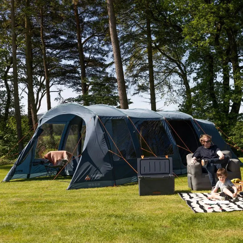 Family camping outdoors with a large tent Vango Savannah 600xl Poled tent in a wooded area