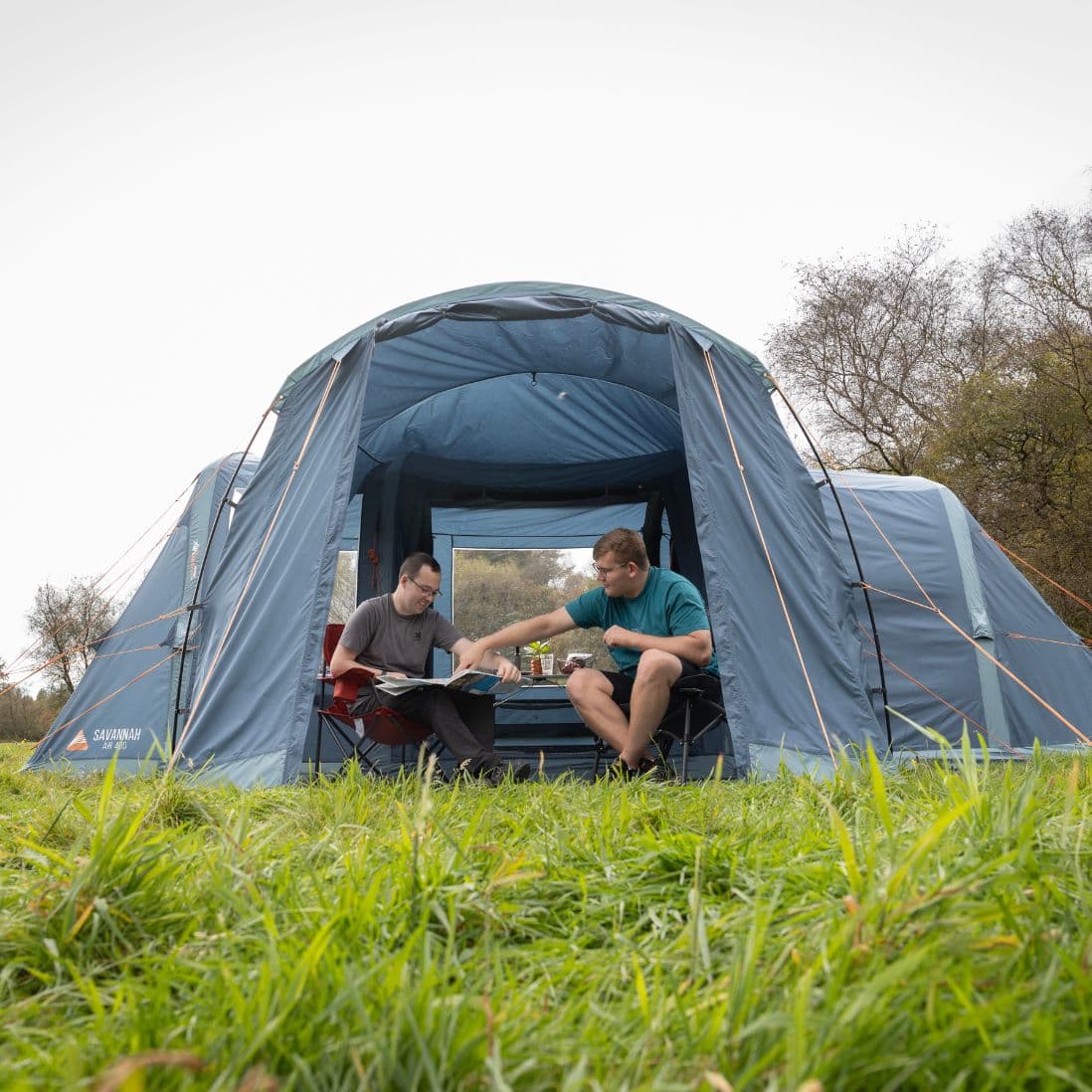 Vango Sentinel Side Awning in a campsite setting with people enjoying its shade and functionality.