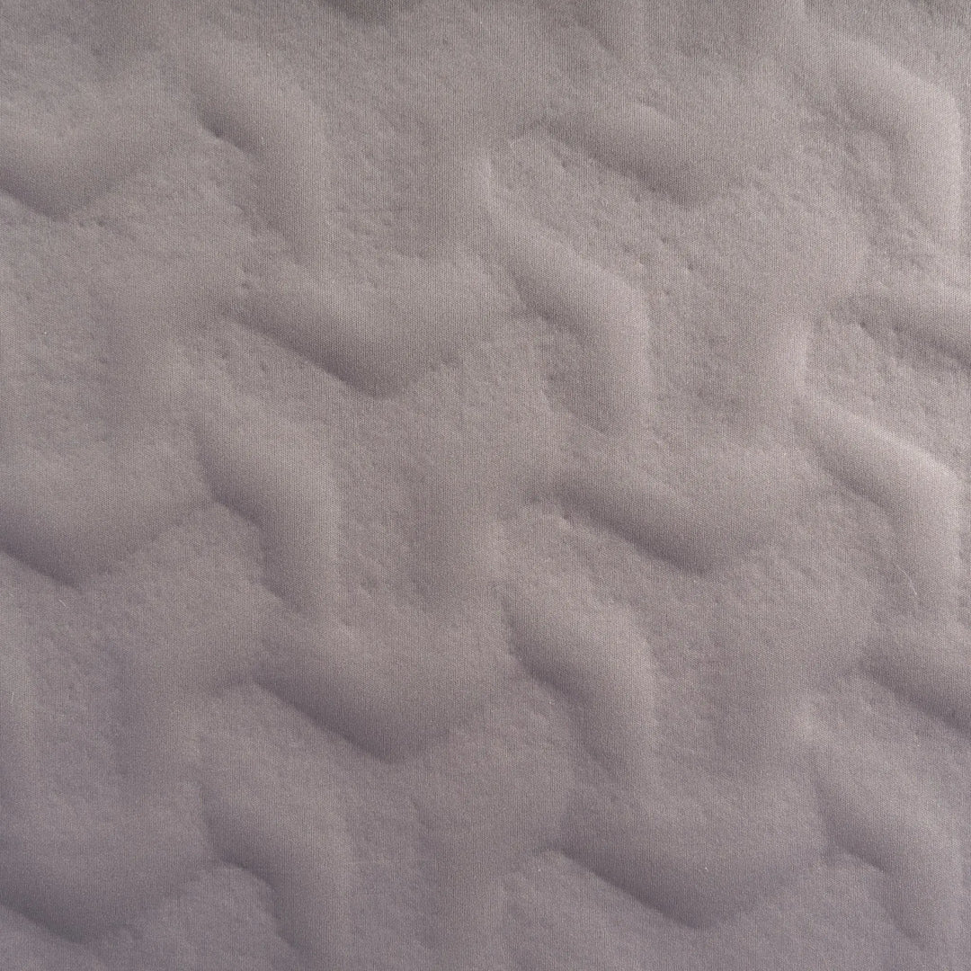 Close-up of textured gray fabric on the Vango Shangri-La Lux 16cm Grande Camping Mattress