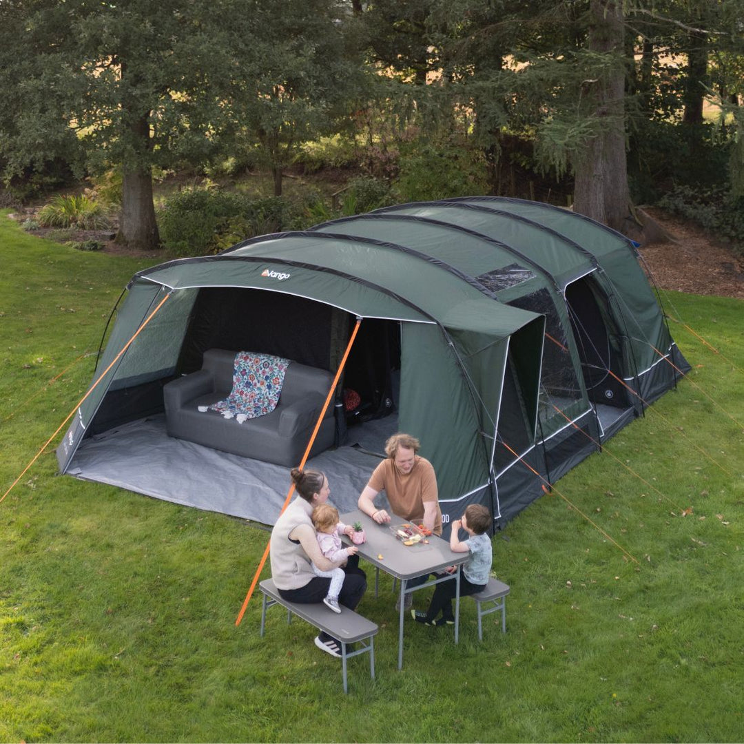 A side view of the Vango Sherwood 600XL Poled Tent, featuring its large front awning and side doors, designed for a comfortable family camping experience.