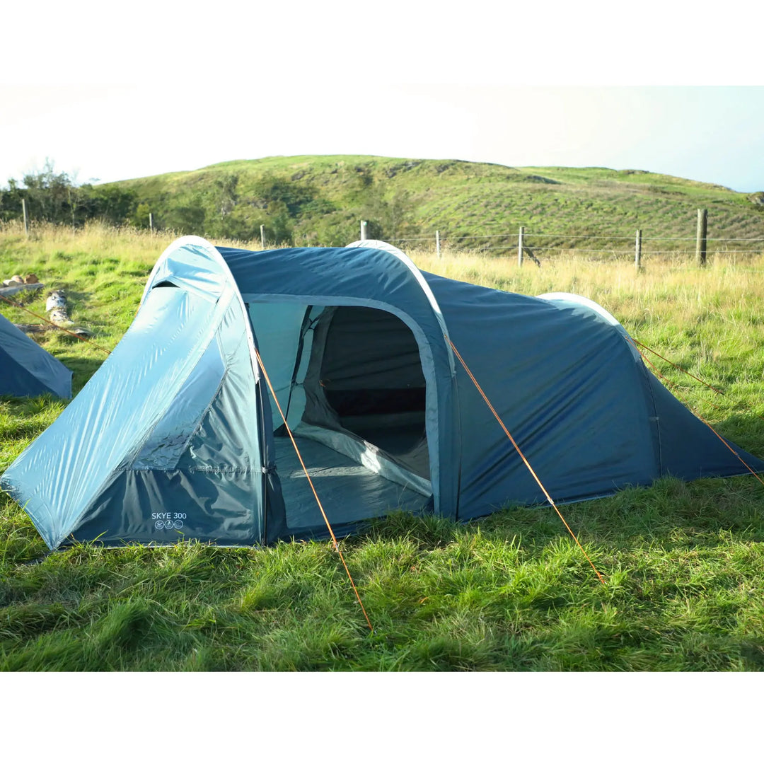 Vango Skye 300 tent pitched outdoors with front door open, showing inner bedroom entrance and linked-in groundsheet.