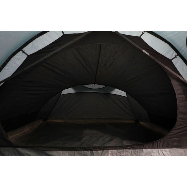 Interior view of the Vango Skye 400 tent's darkened bedroom, designed for better sleep during festival weekends or outdoor adventures.