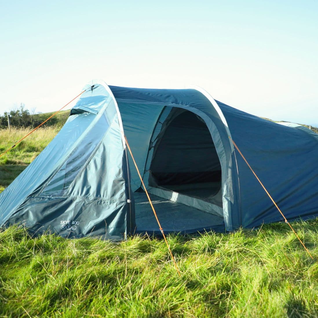 Side view of the Vango Skye 400 Tent pitched outdoors, featuring its sturdy structure and durable material, perfect as a 4-person festival tent or weekend getaway tent