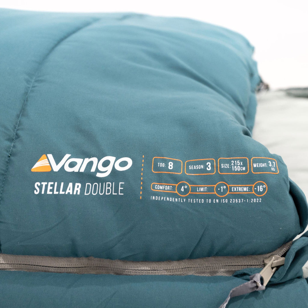 Close-up of the Vango Stellar Double sleeping bag info tag, detailing size, weight, and temperature ratings for adult use.