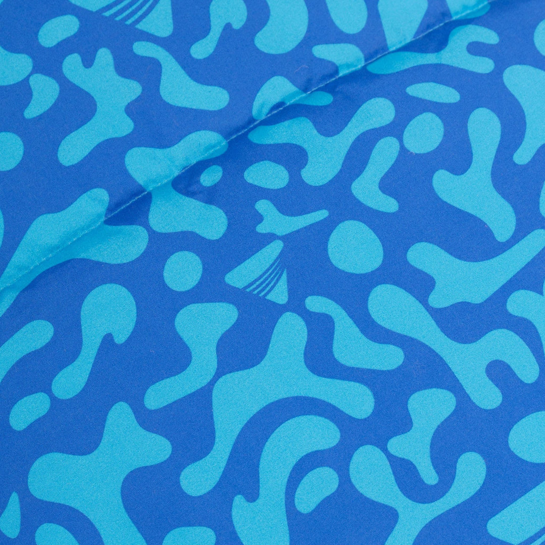 Close-up of the vibrant pattern on the Vango Stellar Junior children's sleeping bag in Atlantic Blue.