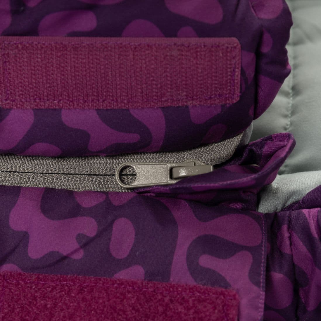 Detailed view of the zip on the Vango Stellar Junior children's sleeping bag in Byzantium, showing durable construction.