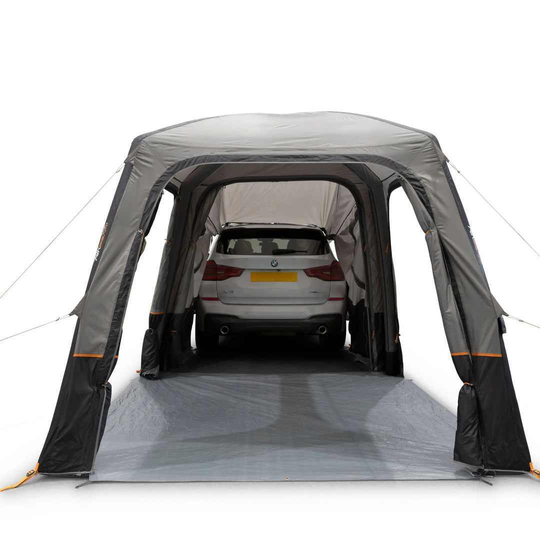 Vango Tailgate AirHub II Low Drive Away Awning with all awning doors open. Attached to rear of a white car.
