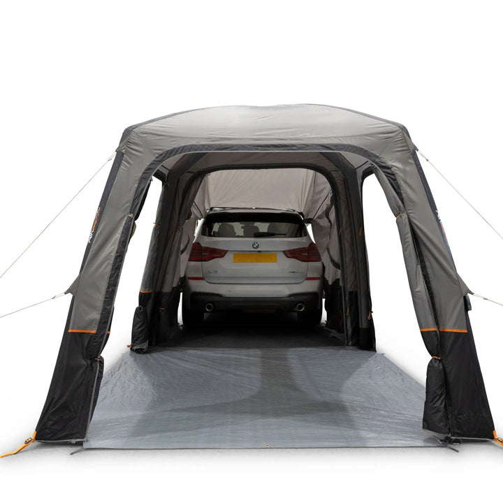 Vango Tailgate AirHub II Low Drive Away Awning with all awning doors open. Attached to rear of a white car.