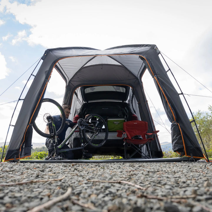 Front and side view of the Vango Tailgate Hub II Low awning, showing its structured design and compatibility with campervans for enhanced outdoor living.