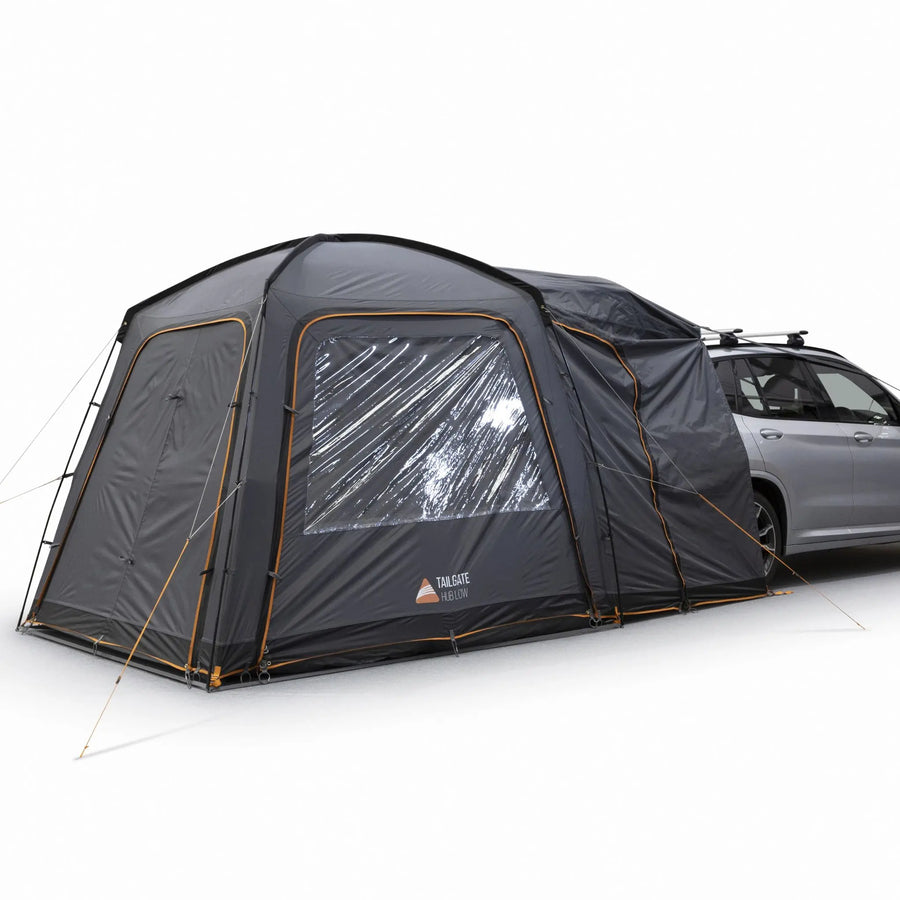 Side view of the Vango Tailgate Hub II Low Awning attached to a campervan, showcasing the durable design and compatibility with cars, SUVs and campervans vehicles.