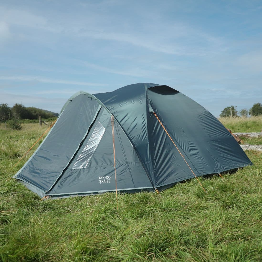 Side view of the Vango Tay 400 4 man tent in an outdoor environment, featuring its stable construction and clear PVC windows, ideal for festival camping.