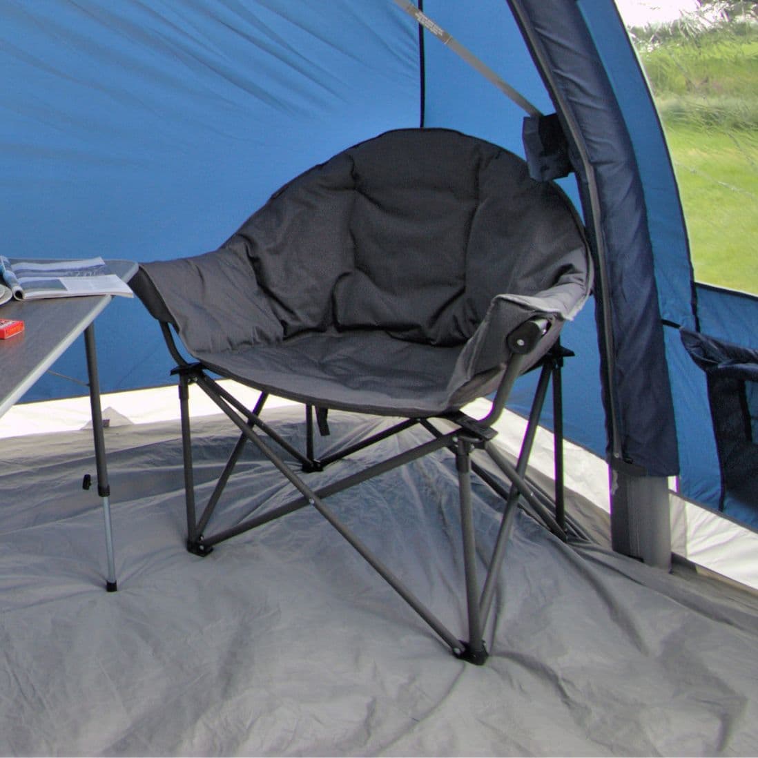 Vango Titan 2 Chair displayed in a relaxed setting, ideal for camping with its durable frame and 180kg weight limit.