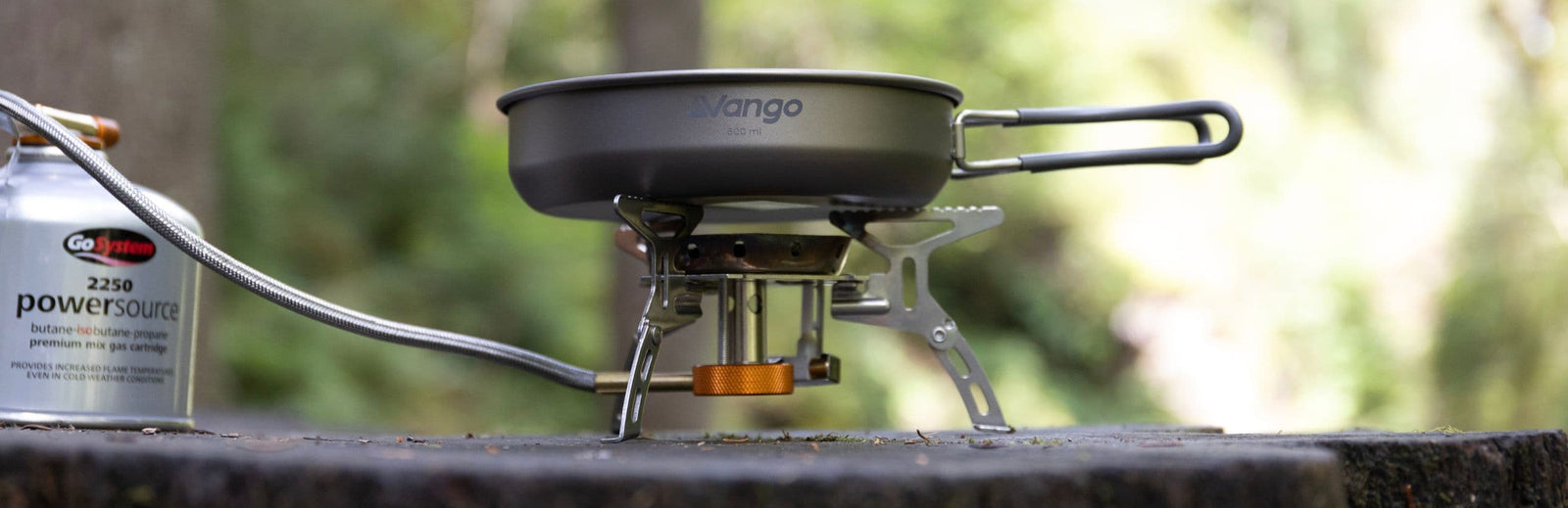 Side view of Vango Titanium 2 Piece Cook Set on a stove with a gas canister, showing compact and lightweight outdoor cookware.