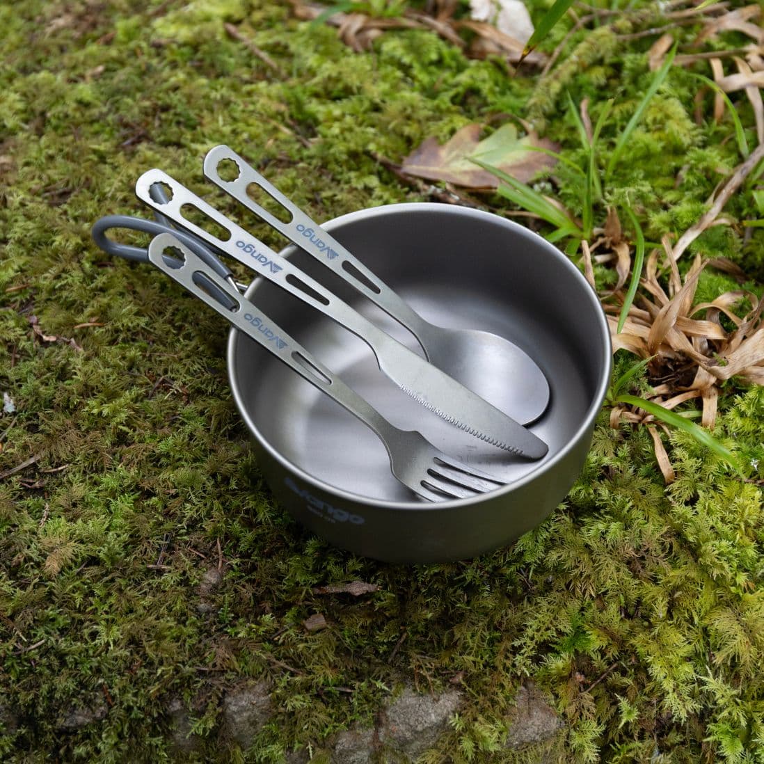 Vango Titanium cutlery set neatly placed inside a camping bowl, showing the fork, spoon, and knife as compact and durable camping utensils.