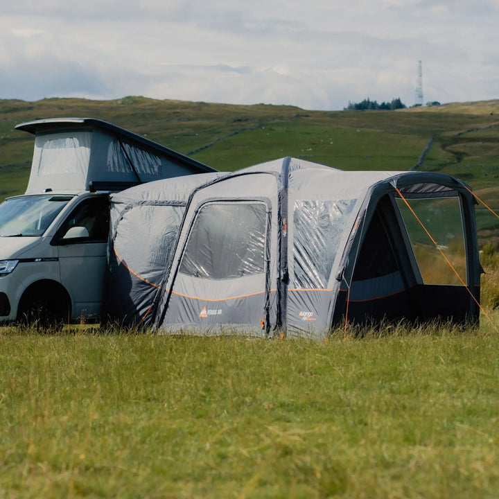 Side view of the Vango Versos Air Low Drive-Away Awning, showcasing large windows, durable 150D fabric, and connection tunnel to a VW campervan.