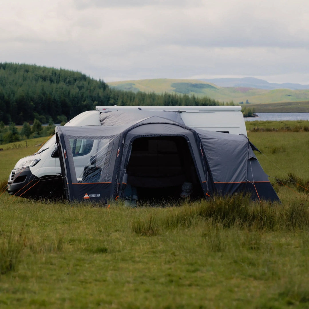 Front view of the Vango Versos Air Mid drive-away awning, designed for  touring, with large doors and clear windows for natural light.