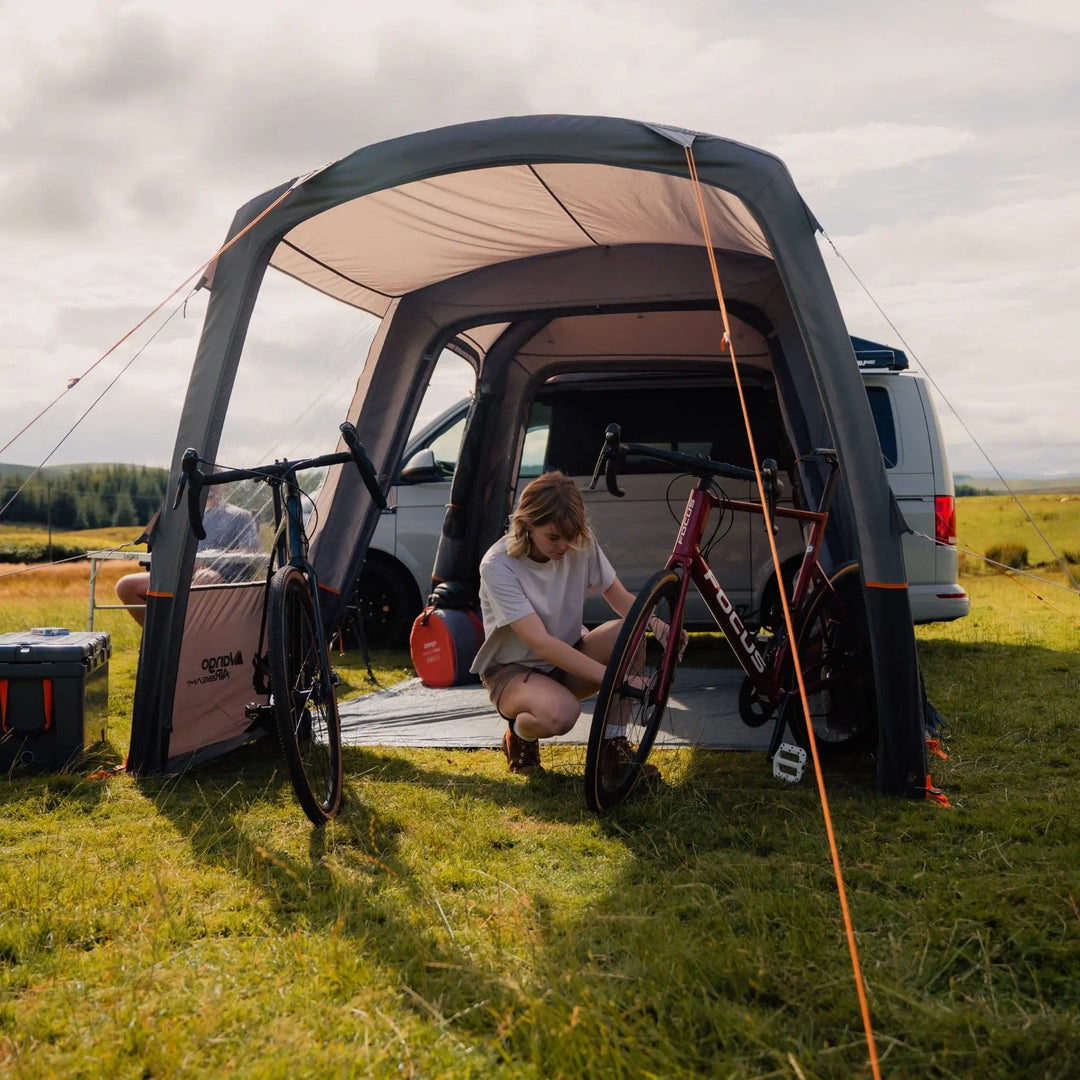 Open-air view of the VW campervan awning, illustrating its spacious interior with bikes stored inside.